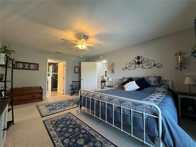 carpeted bedroom featuring ceiling fan and a textured ceiling