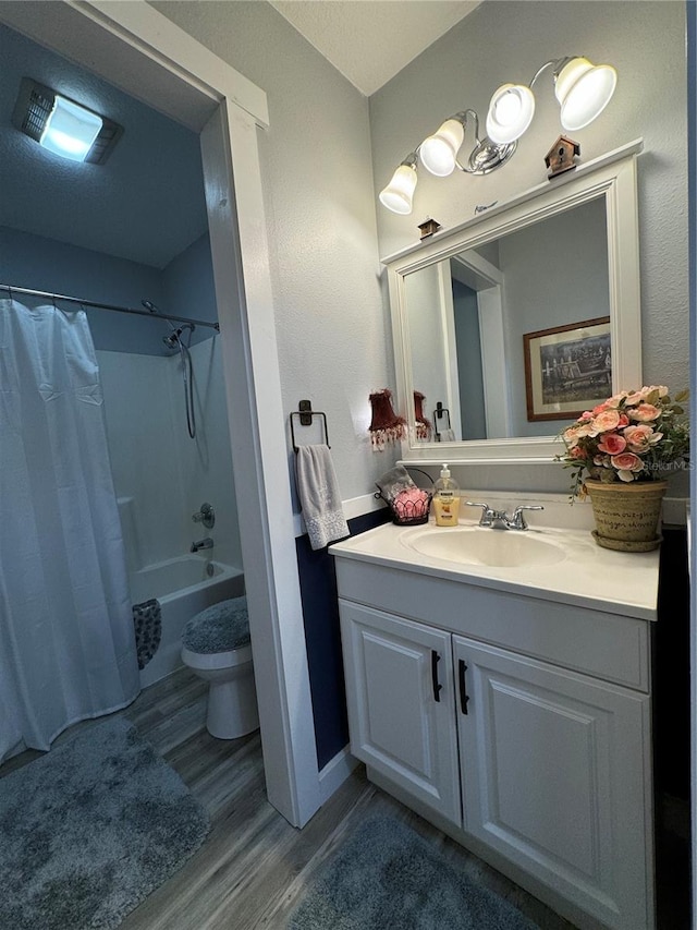 full bathroom featuring toilet, vanity, shower / tub combo, and hardwood / wood-style flooring