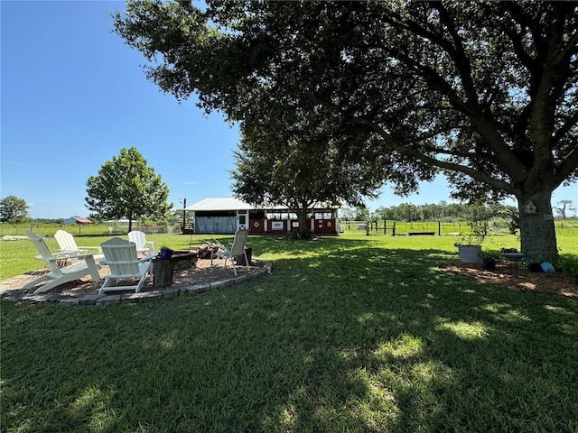 view of yard with an outbuilding and an outdoor fire pit