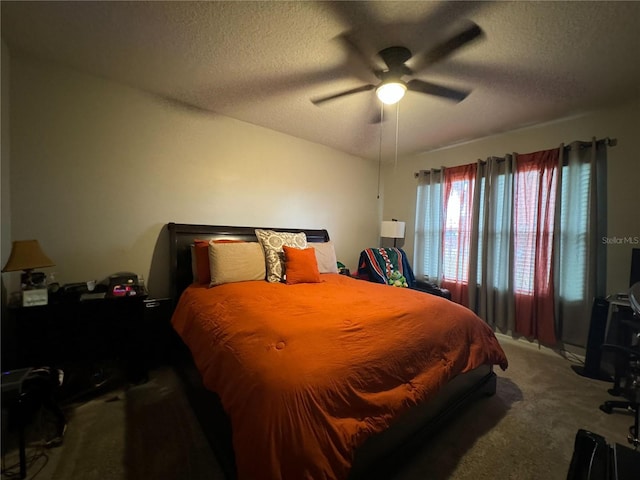 carpeted bedroom with a textured ceiling and ceiling fan