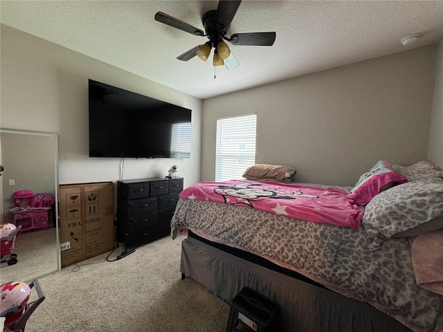 carpeted bedroom with a textured ceiling and ceiling fan