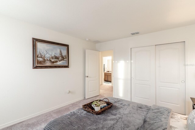 unfurnished bedroom with light carpet and a closet