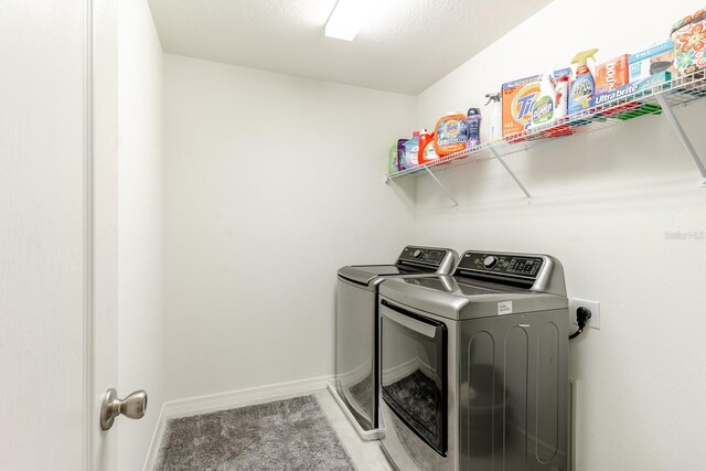 washroom featuring washer and clothes dryer