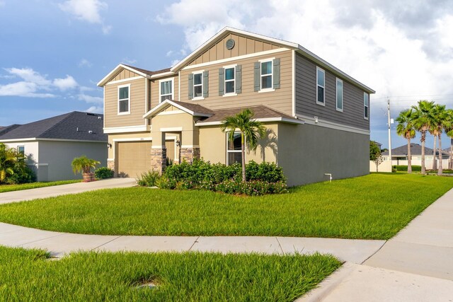 view of front of property with a front yard and a garage