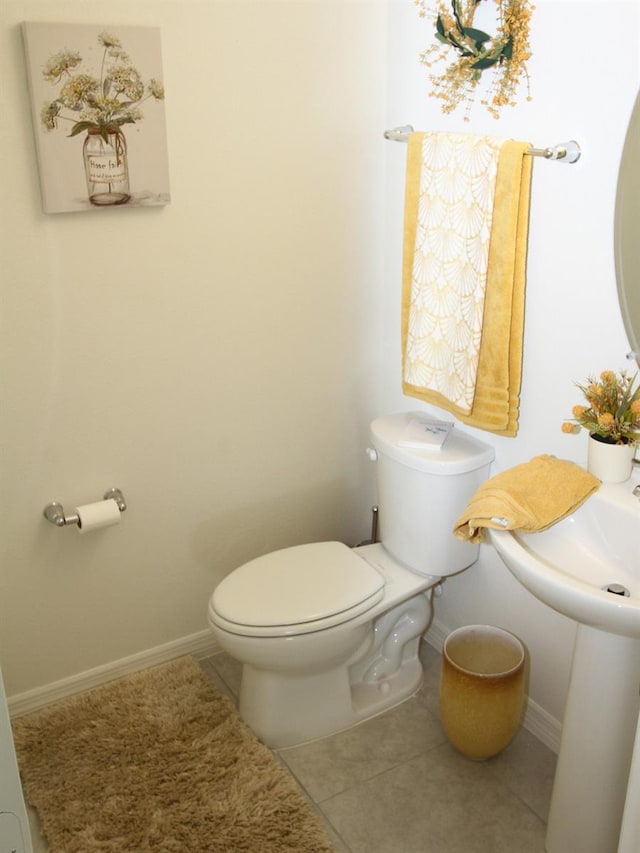 bathroom with tile patterned flooring and toilet