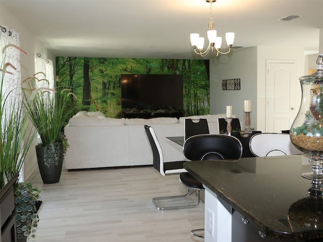 dining room featuring a notable chandelier and light hardwood / wood-style floors