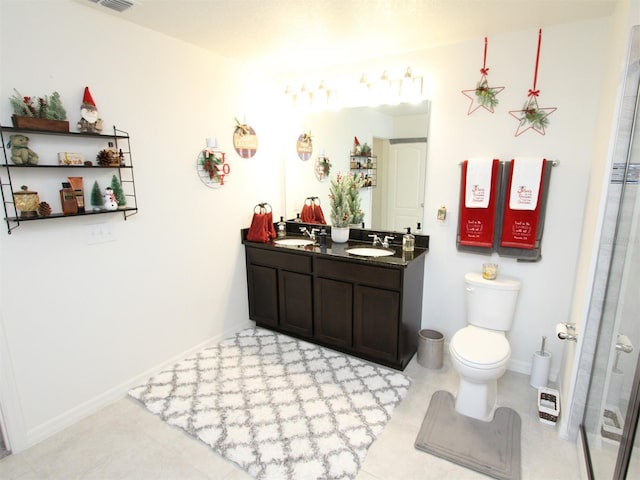 bathroom featuring vanity, toilet, and a shower with door