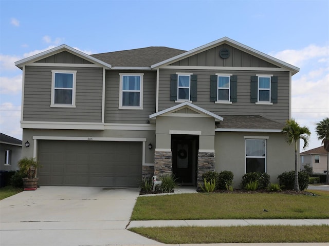 view of front of home featuring a garage and a front lawn