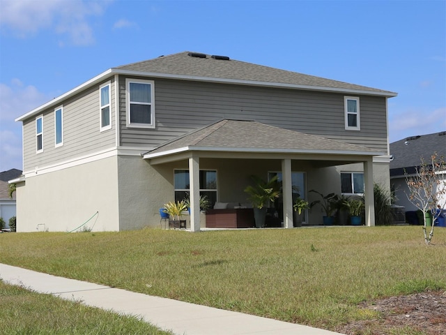 rear view of property featuring a yard