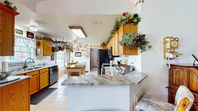 kitchen featuring ceiling fan, sink, black dishwasher, light tile patterned flooring, and stove