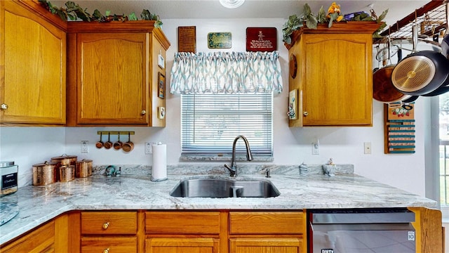 kitchen with sink and light stone counters