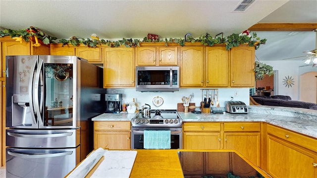 kitchen featuring appliances with stainless steel finishes and ceiling fan