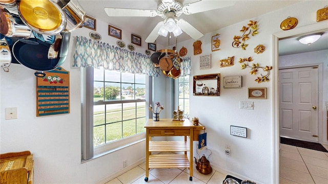 interior space featuring tile patterned flooring and ceiling fan