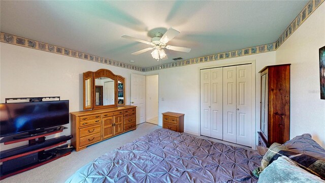 bedroom featuring ceiling fan, a closet, and carpet floors