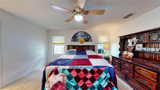 bedroom featuring ceiling fan and light carpet