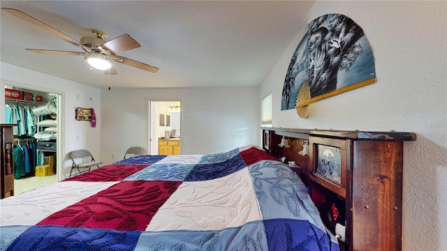 bedroom featuring ceiling fan, a spacious closet, a closet, and ensuite bathroom