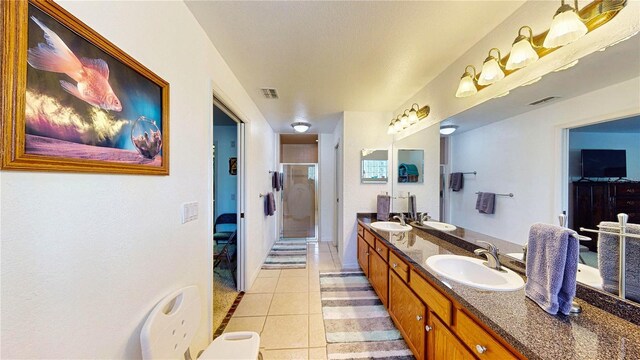 bathroom featuring an enclosed shower, vanity, and tile patterned floors