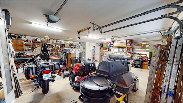 garage featuring ceiling fan, a workshop area, and a garage door opener