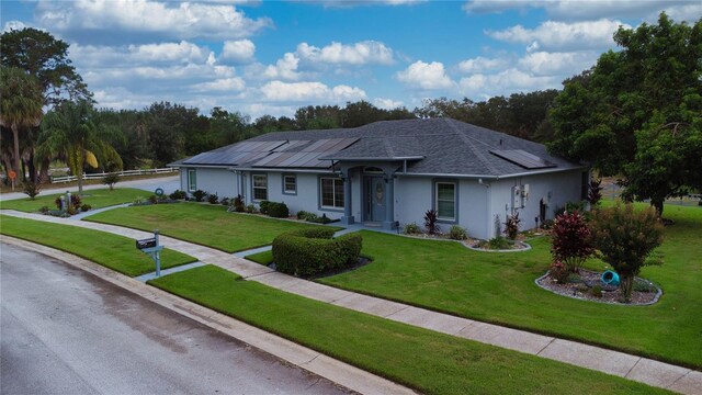 ranch-style house with a front lawn