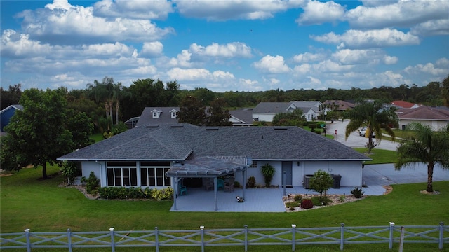 ranch-style house with a front yard and a patio area