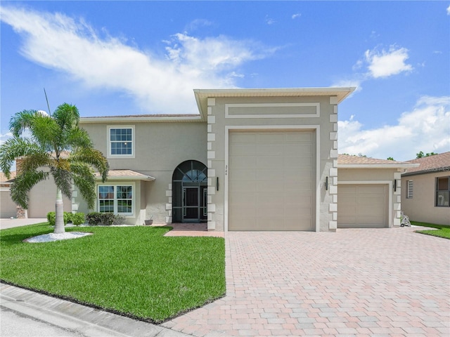 view of front facade featuring a garage and a front lawn