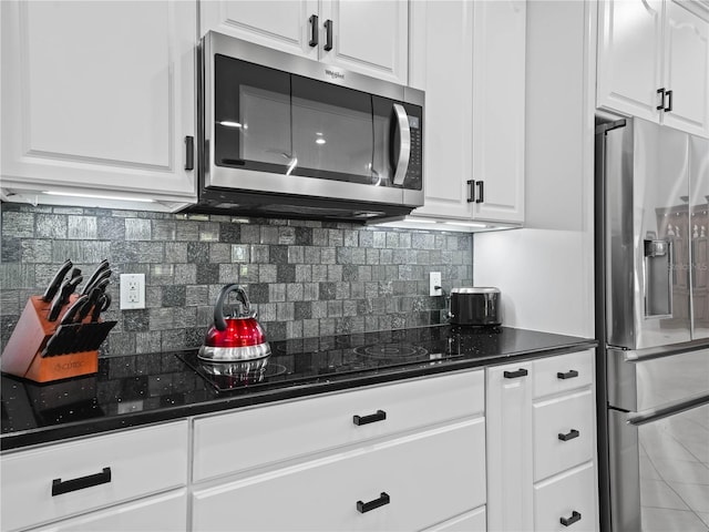 kitchen featuring white cabinets, backsplash, and stainless steel appliances