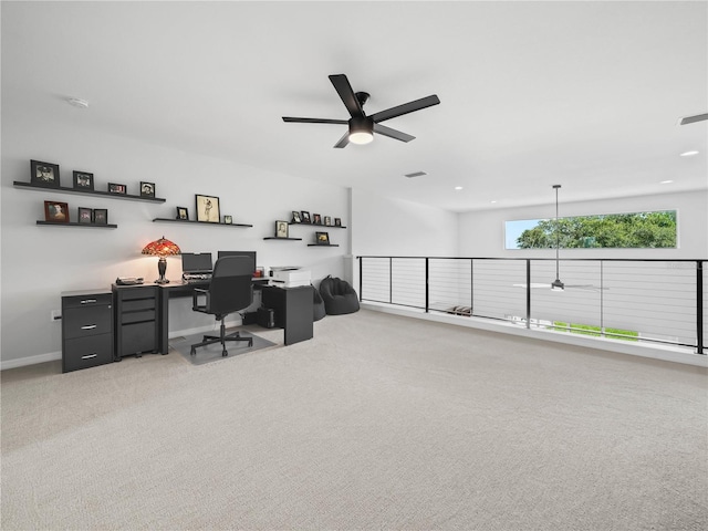 carpeted office featuring ceiling fan