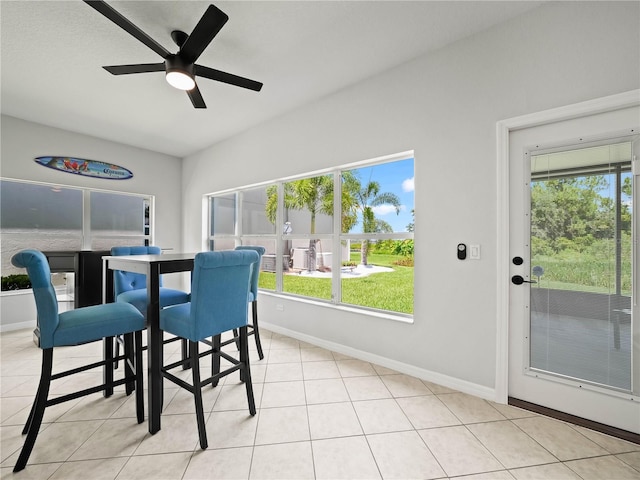 dining space featuring ceiling fan and light tile patterned floors