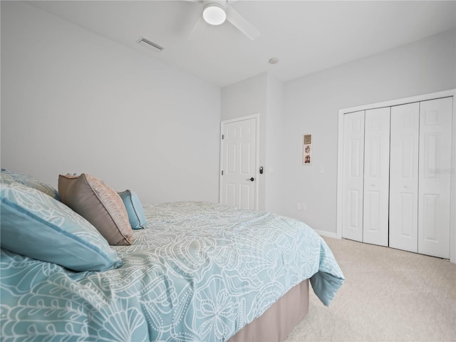 carpeted bedroom with ceiling fan and a closet