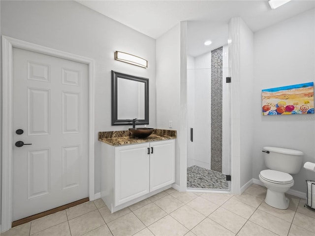 bathroom featuring vanity, toilet, a shower with shower door, and tile patterned floors