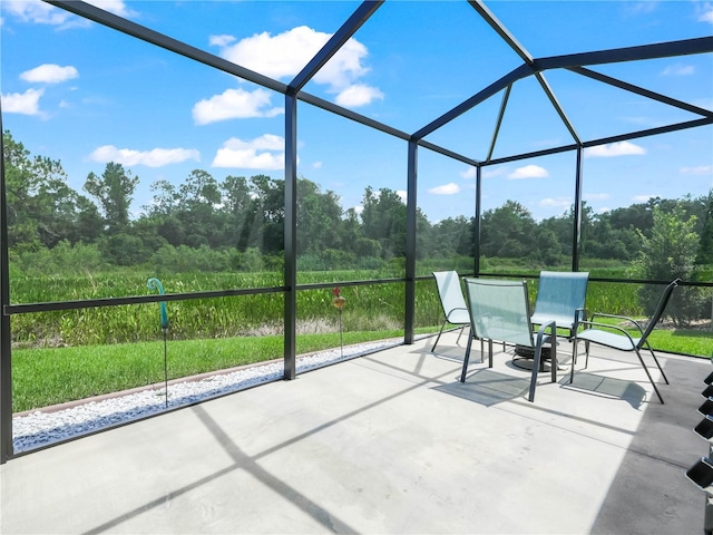 view of patio with glass enclosure