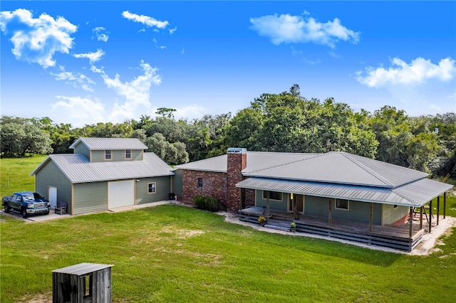 rear view of property with a lawn and a garage