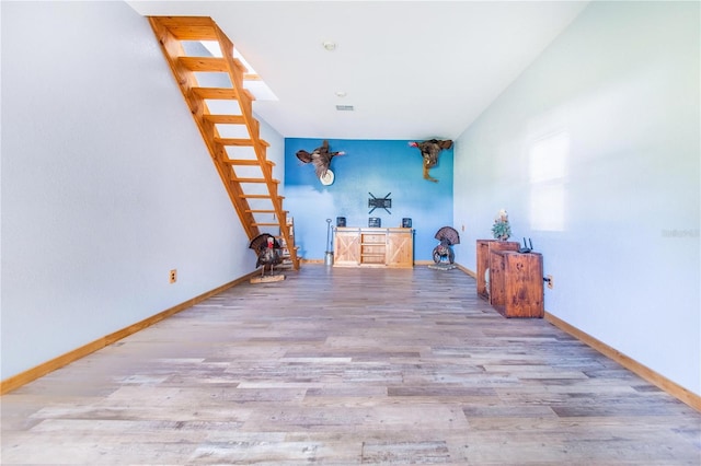 unfurnished room with visible vents, baseboards, and wood finished floors