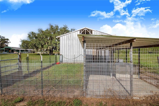 view of gate featuring an outbuilding