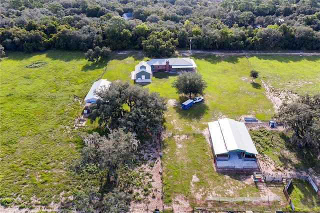 drone / aerial view featuring a wooded view