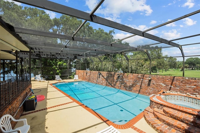 view of swimming pool with a lanai and a patio area