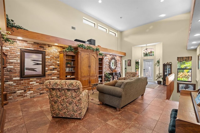 living room with a notable chandelier, a high ceiling, and tile patterned flooring