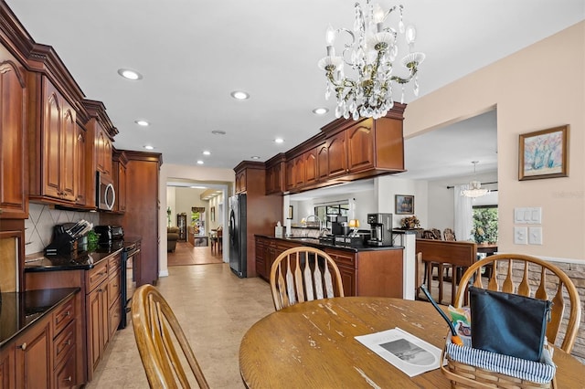 dining area featuring an inviting chandelier and sink