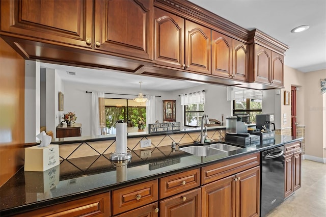 kitchen featuring black dishwasher, dark stone counters, kitchen peninsula, and sink