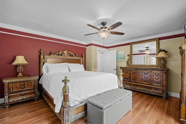 bedroom with ornamental molding, wood-type flooring, and ceiling fan