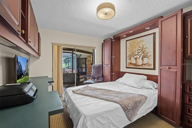 carpeted bedroom featuring a textured ceiling and access to exterior