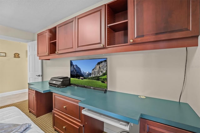 kitchen with a textured ceiling and built in desk