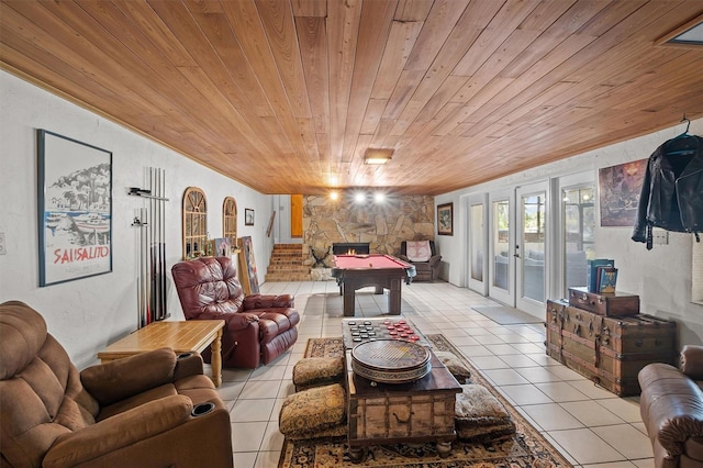 tiled living room with wooden ceiling, french doors, and a fireplace