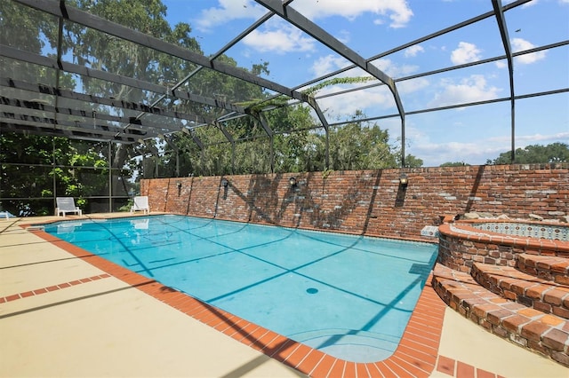 view of swimming pool featuring glass enclosure