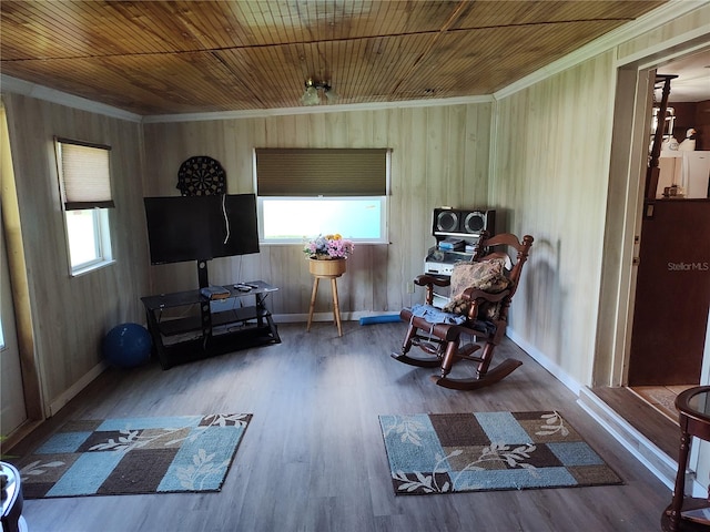 living area with ornamental molding, wood ceiling, and hardwood / wood-style floors