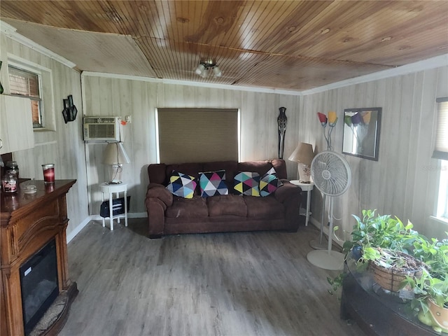 living room featuring wood-type flooring, wood ceiling, crown molding, and a wall mounted air conditioner