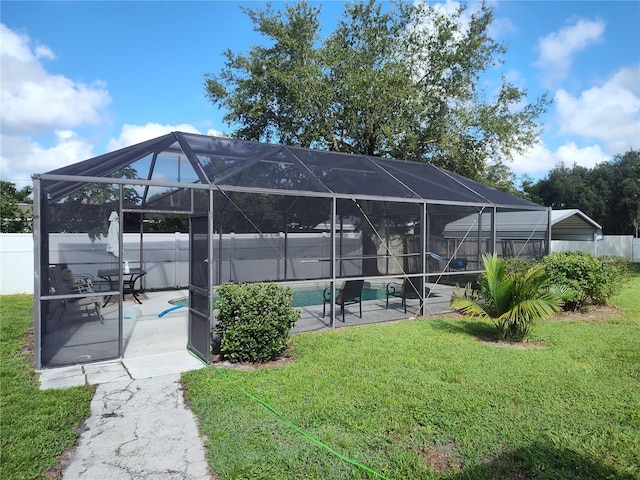 exterior space with a fenced in pool, glass enclosure, and a patio area