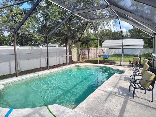 view of swimming pool with a patio area and glass enclosure