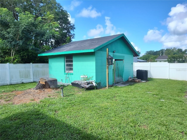 view of outdoor structure featuring a lawn