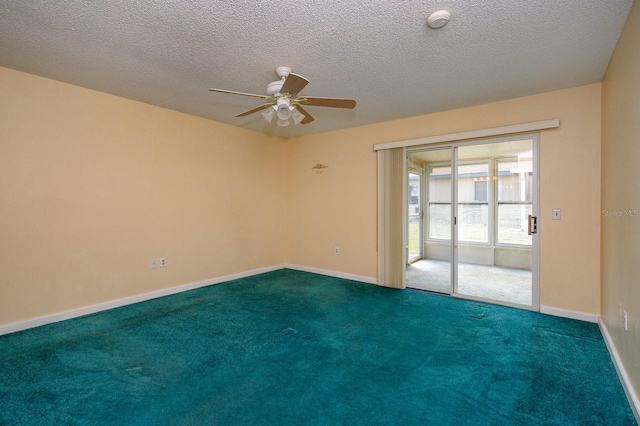 carpeted spare room with ceiling fan and a textured ceiling